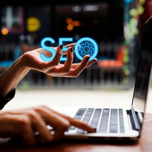 Person holding an "SEO" graphic